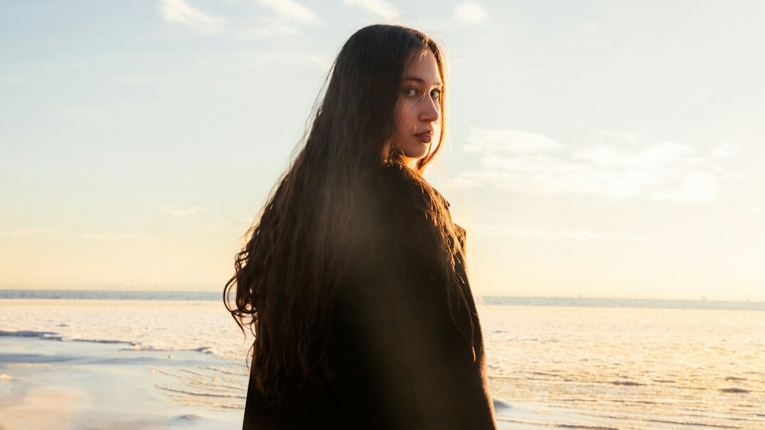 Portrait of a young woman with long hair smiling
